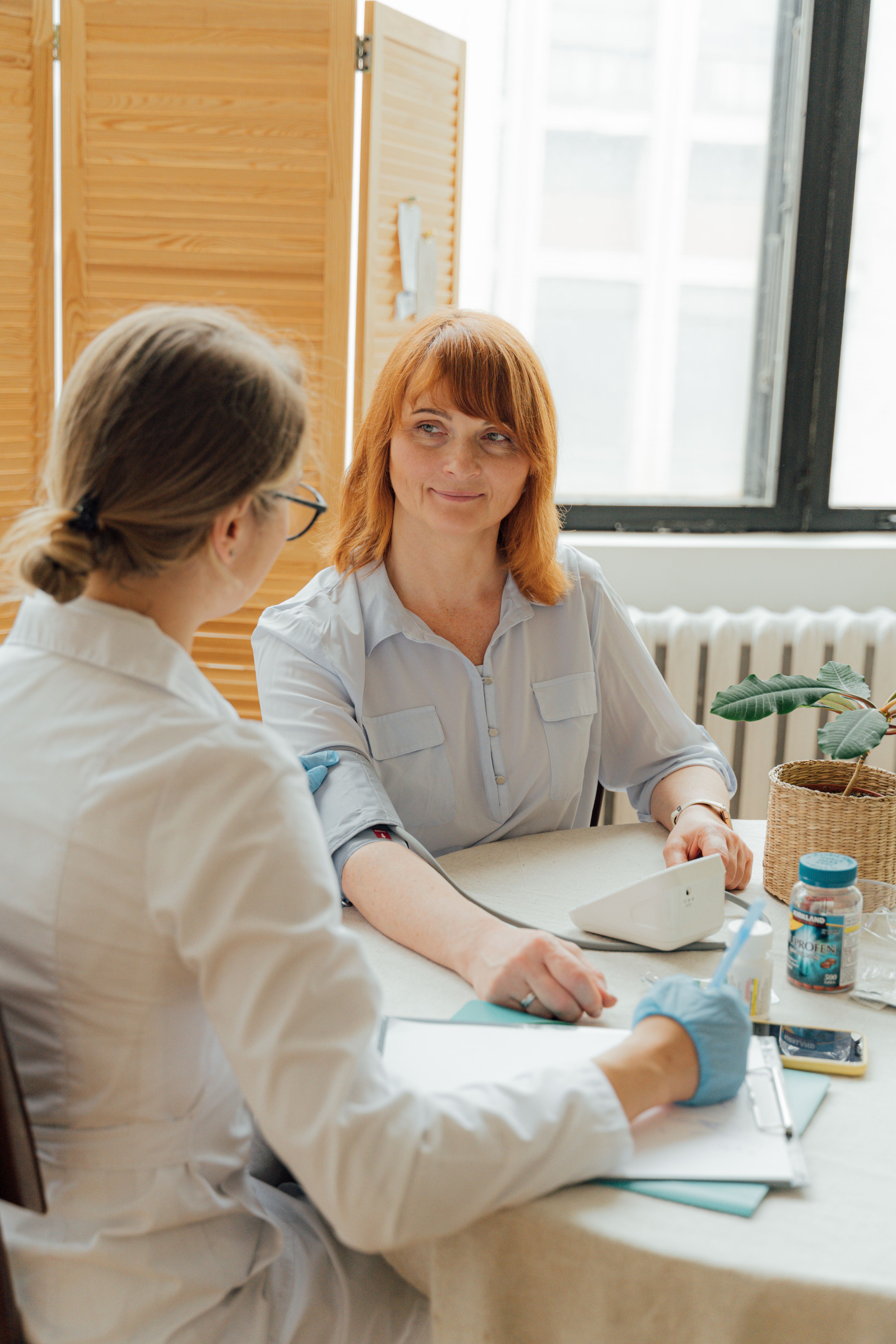 Female clinician discussing gynecologic symptoms with a patient